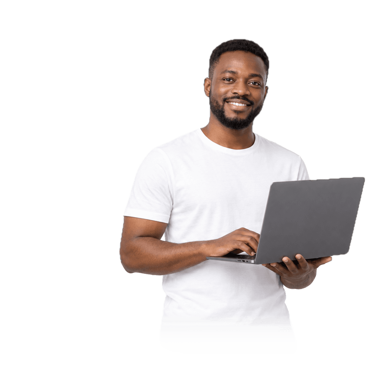A man in a white t-shirt working on a laptop