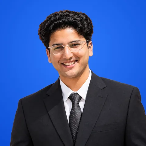 Haseeb Raza, web and AI systems lead at WaseerHost, smiling in glasses and a black suit
